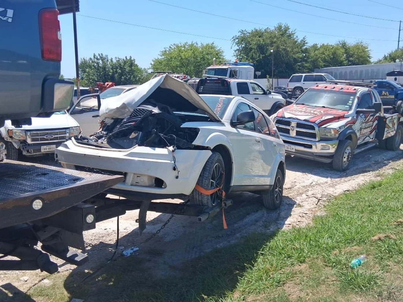 Wrecked car loaded onto a flatbed tow truck