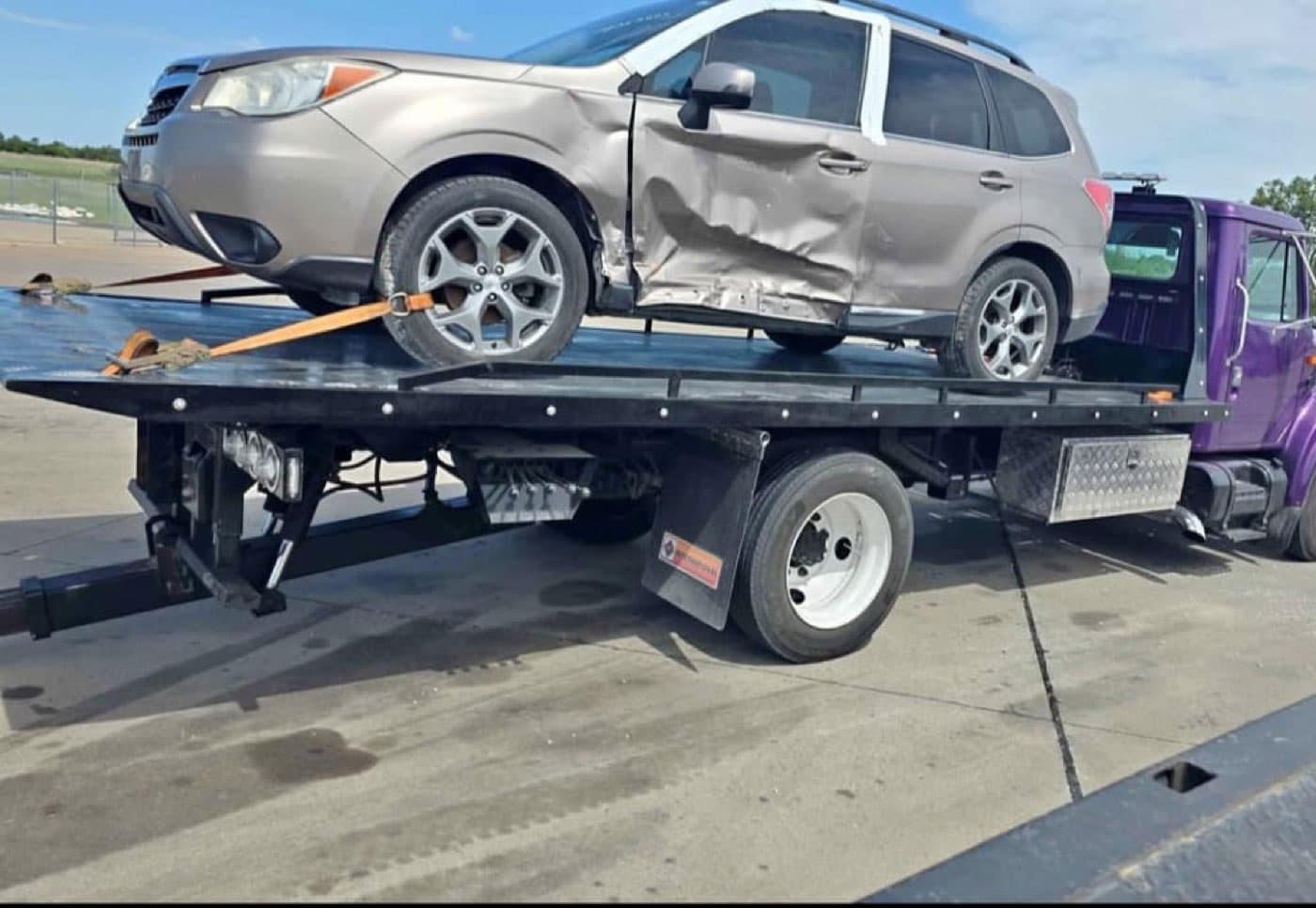 SUV with side damage on the tow truck